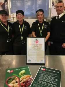 The team at the Atrium Café pictured in front of their Gold Eat out Eat Well